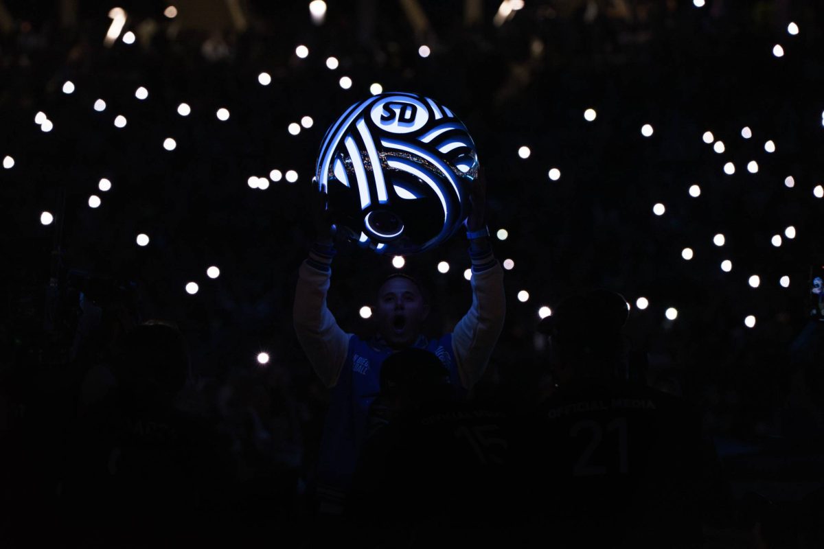 San Diego Padres player Manny Machado, part owner of San Diego FC, holds a glowing San Diego soccer ball during the opening ceremony for San Diego FC's inaugural home opener at Snapdragon Stadium on March 1.