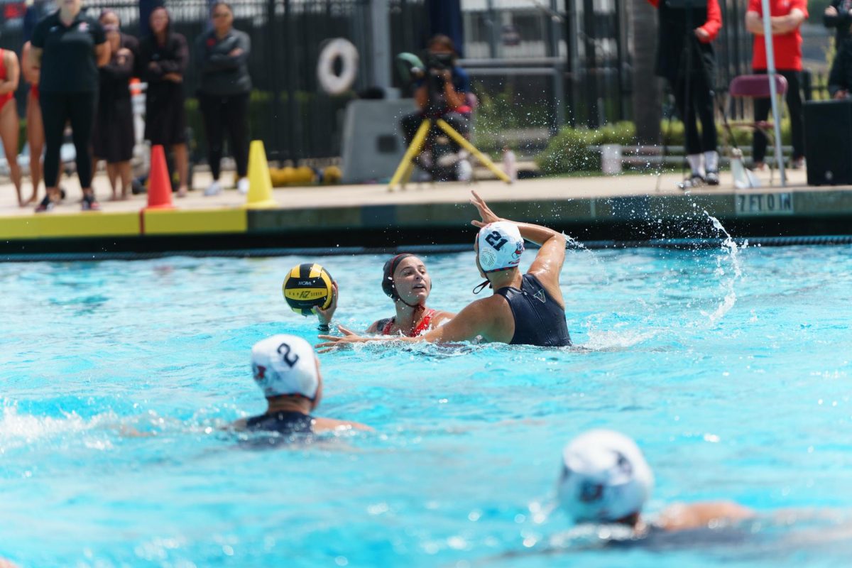 San Diego State defender Sofia Righetti looks past the Fresno State pressure toward the goal at the Aztec Aquaplex on March 29, 2025.