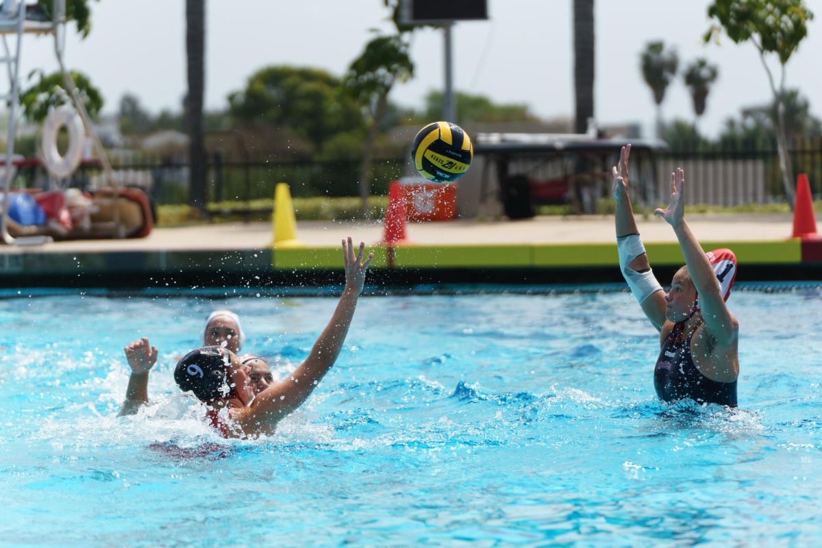 San Diego State center Hannah Bell attempts to lob the ball over the Fresno State goalie at the Aztec Aquaplex on March 29, 2025.