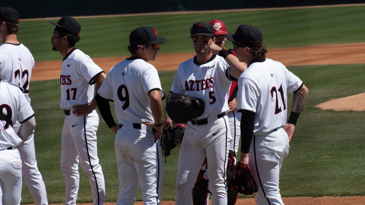 Nevan Noonan speaks with his teammates before first pitch at Tony Gwynn Stadium