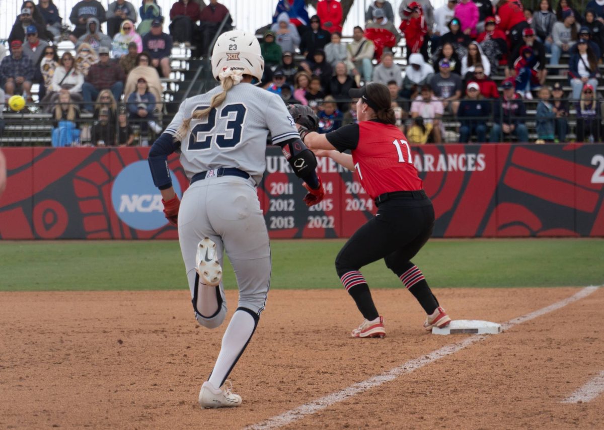 San Diego State catcher Shannon Cunningham outs an Arizoner runner at first base on April 26, 2025, at SDSU Softball Stadium