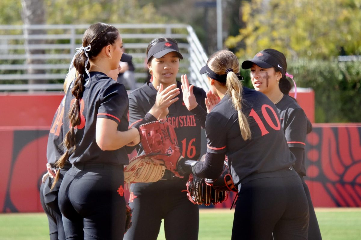 San Diego State infielder Quinn Waiki joins in a group huddle during a game against CSUN on February 6, 2025 at SDSU Softball Stadium. 