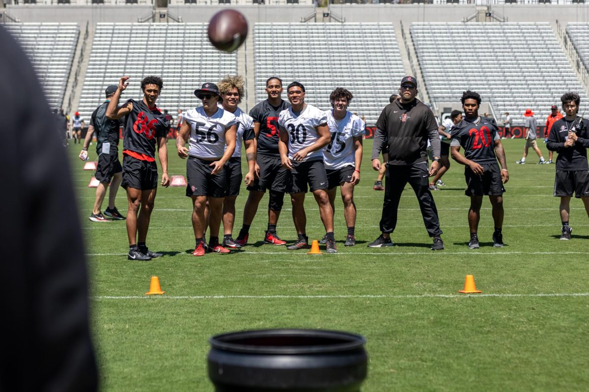 Several Aztec football players watch in anticipation at Snapdragon Stadium on April 19th, 2025.