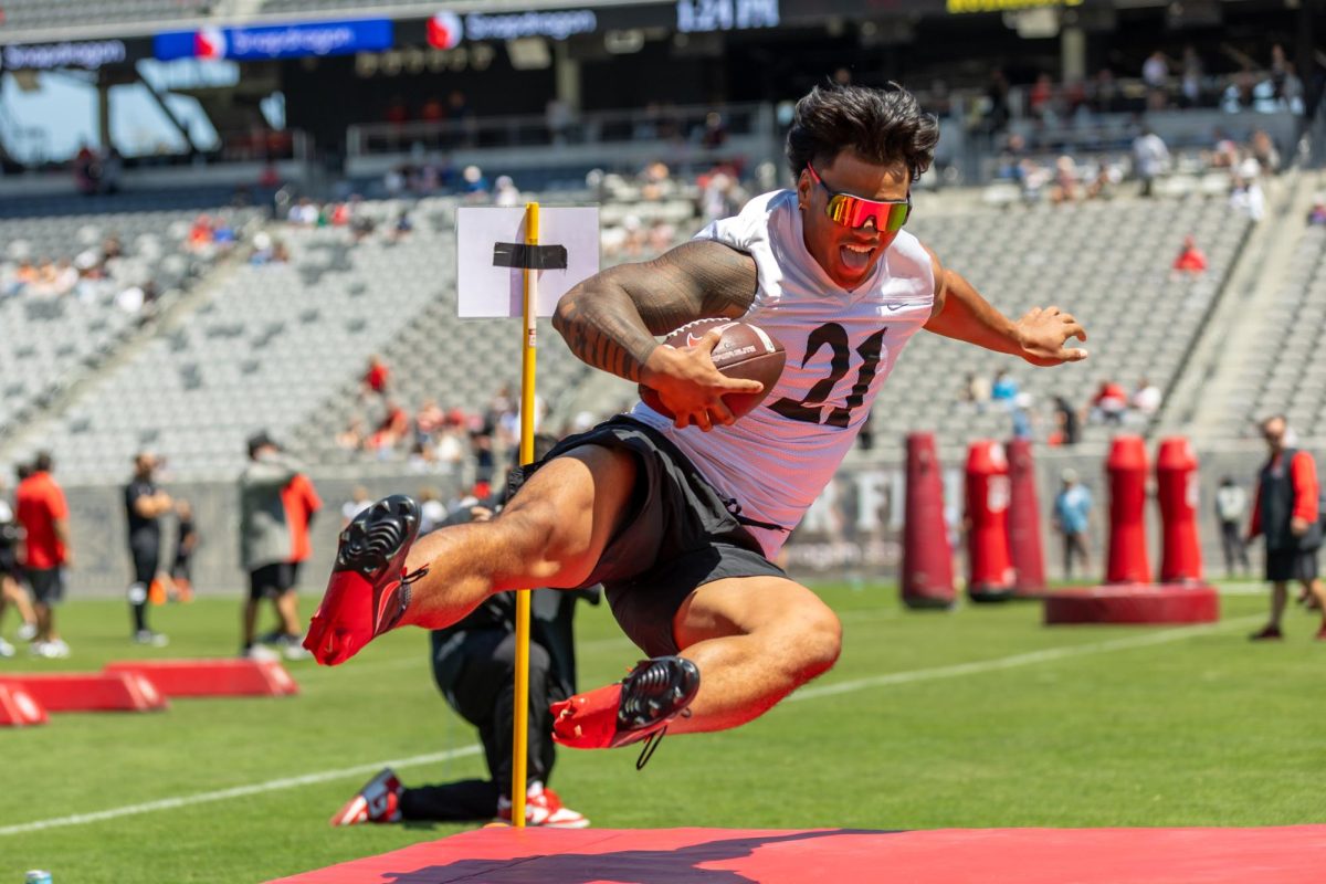 San Diego State linebacker Tano Letuli poses as he dives into a landing mat at Snapdragon Stadium on April 19th, 2025.