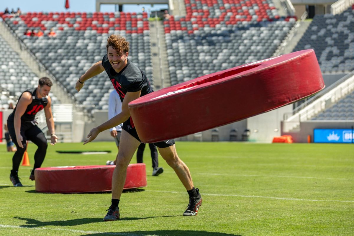 San Diego State football players throw their tackle wheels at Snapdragon Stadium on April 19th, 2025.