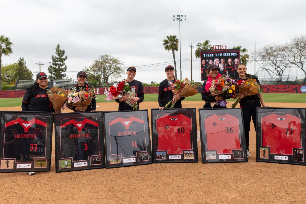 From left to right, Dee Dee Hernandez (33), Bella Espinoza (3), Cali Decker (11), Kate Farren (10), Sav Adams (26) and Grace Ubribe (23) celebrate their accomplishments on Senior Day on Saturday, May 3, 2025, at SDSU Softball Stadium, Calif.