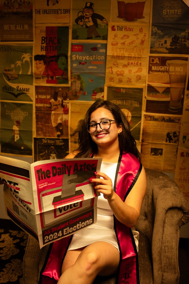 Hannah Psalma Ramirez poses with a print edition of The Daily Aztec in the newsroom on Saturday, Apr. 12 2025 at San Diego State University. (Photo by Penelope Cornell)