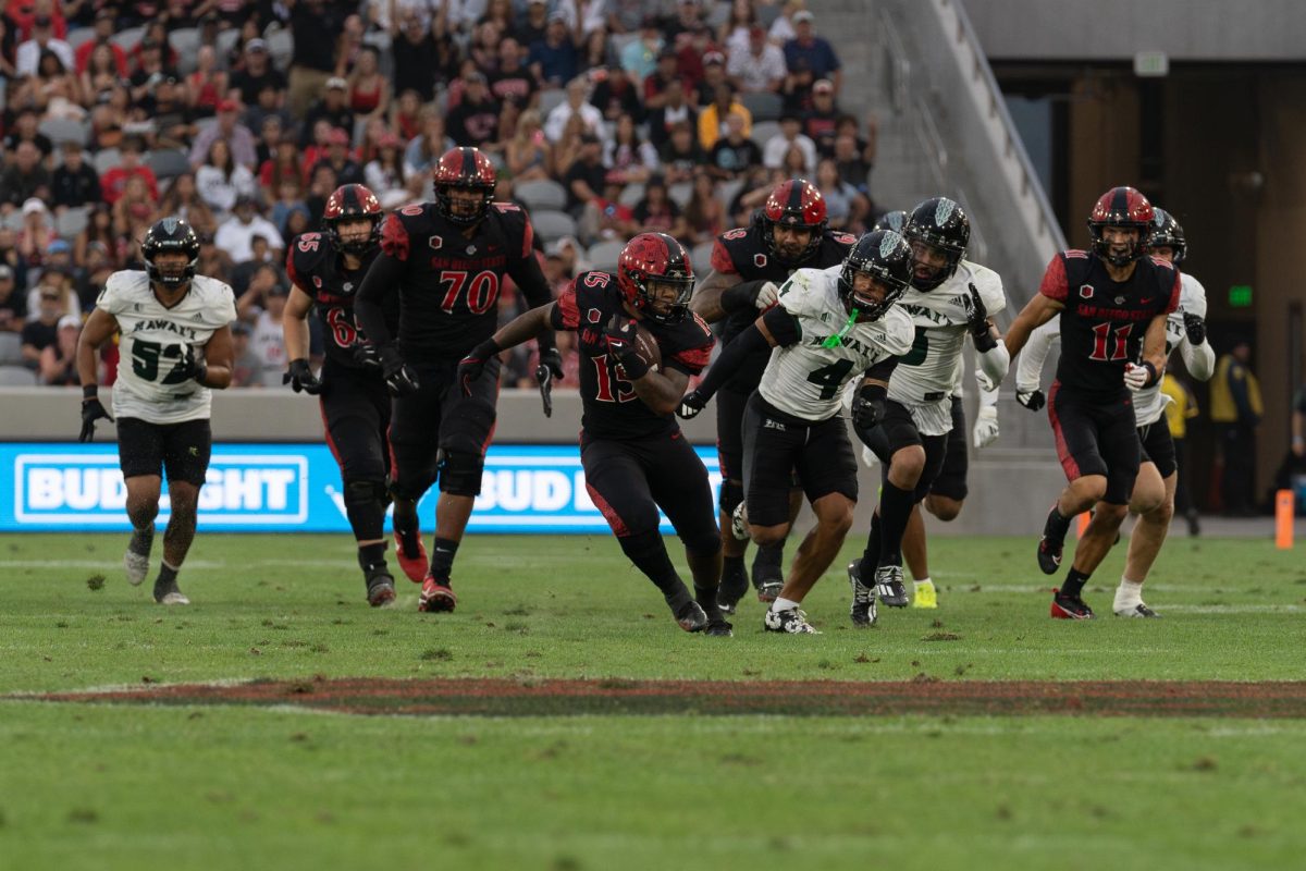 Former San Diego State running back Marquez Cooper rushes past Hawaii’s defense at Snapdragon Stadium on Saturday October 5, 2024