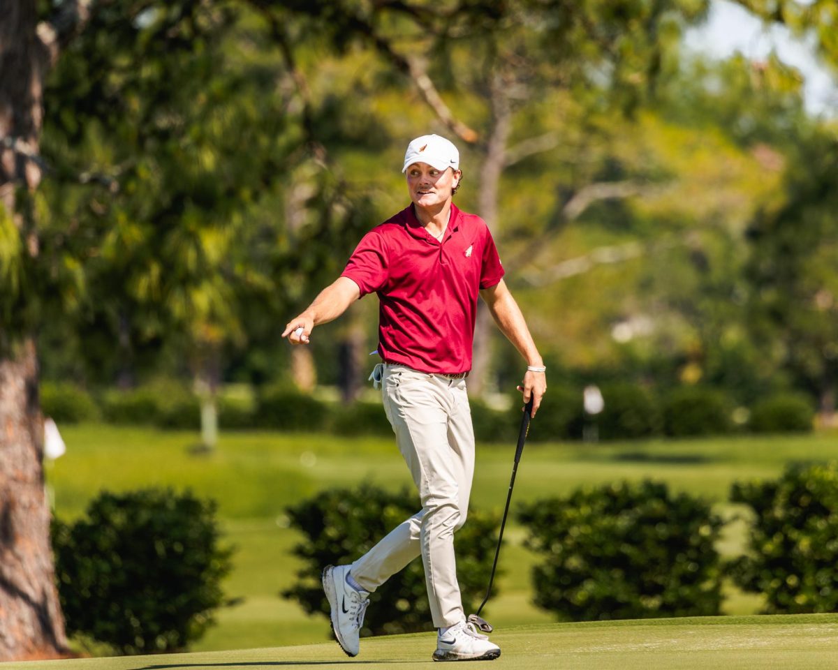 FSU junior Luke Clanton talks with one of his opponents as he heads to the next tee box. Photo Courtesy of FSU Athletics.