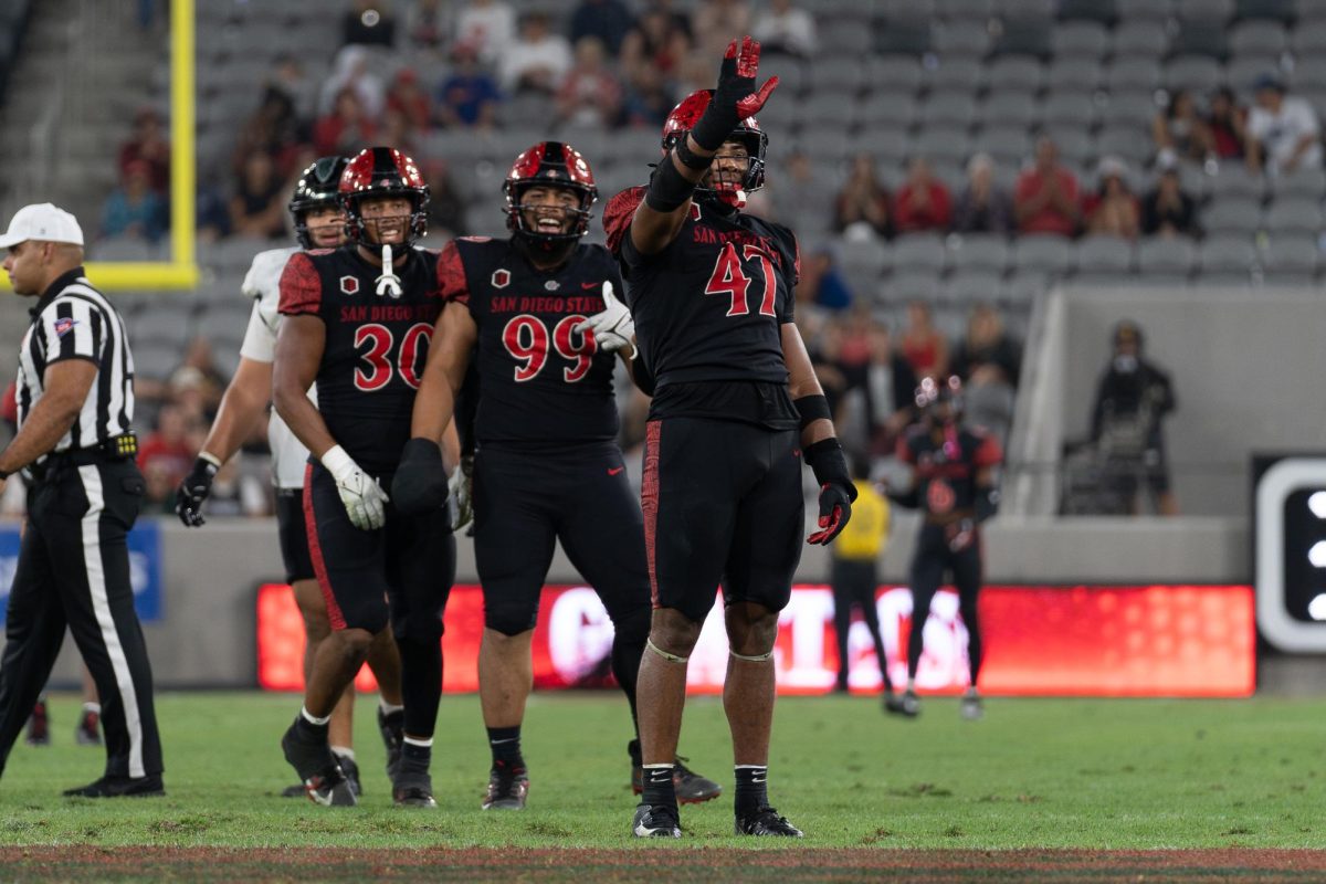 San Diego State junior edge rusher Trey White waves to the crowd celebrating a sack against Hawaii during a game last season at SnapDragon Stadium. 
quarterback Brayden Schager at Snapdragon Stadium on Saturday October 5, 2024