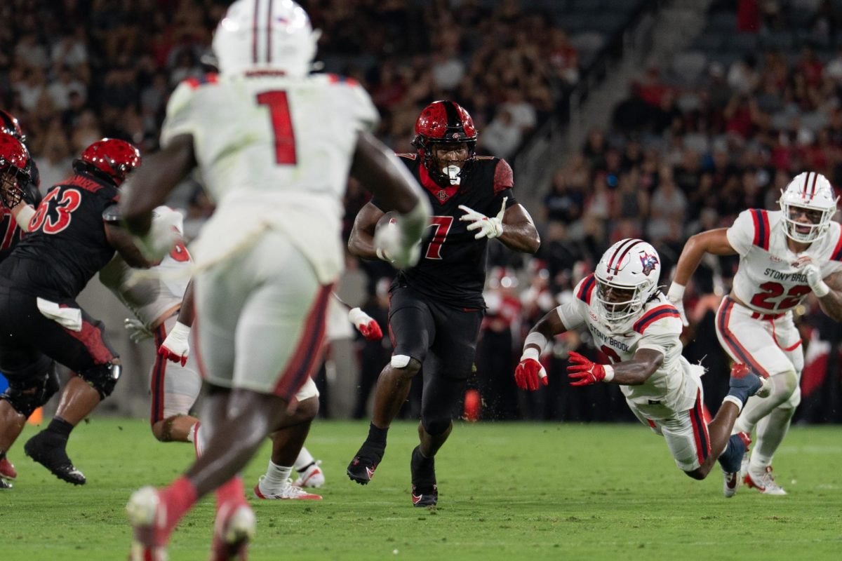 Junior running back Lucky Sutton runs past Stony Brook defender's in a 42-0 win against on August 28, 2025, at Snapdragon Stadium. 