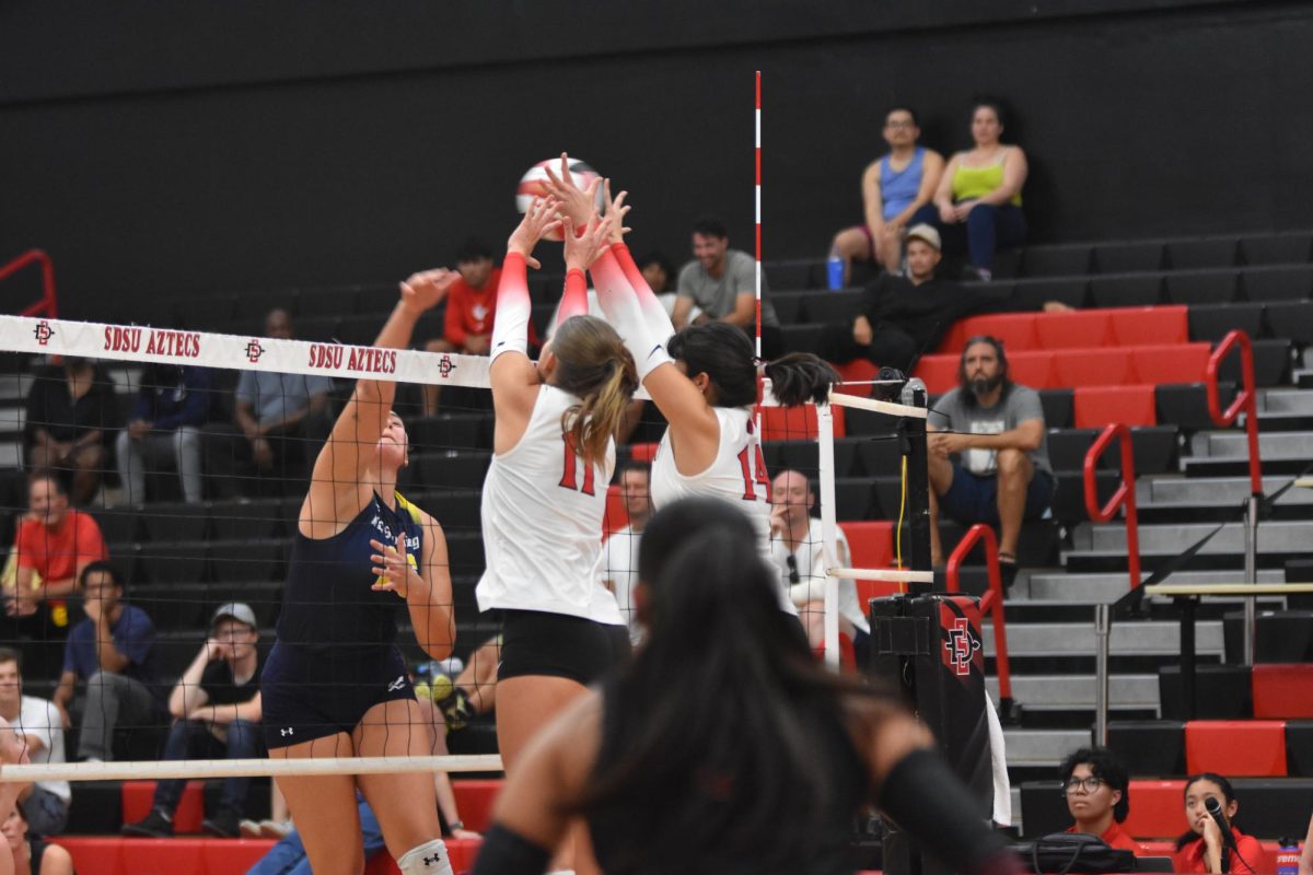 Teammates stuffed UCSD's outside hitter on September 18th, 2025 at Peterson Gym. 