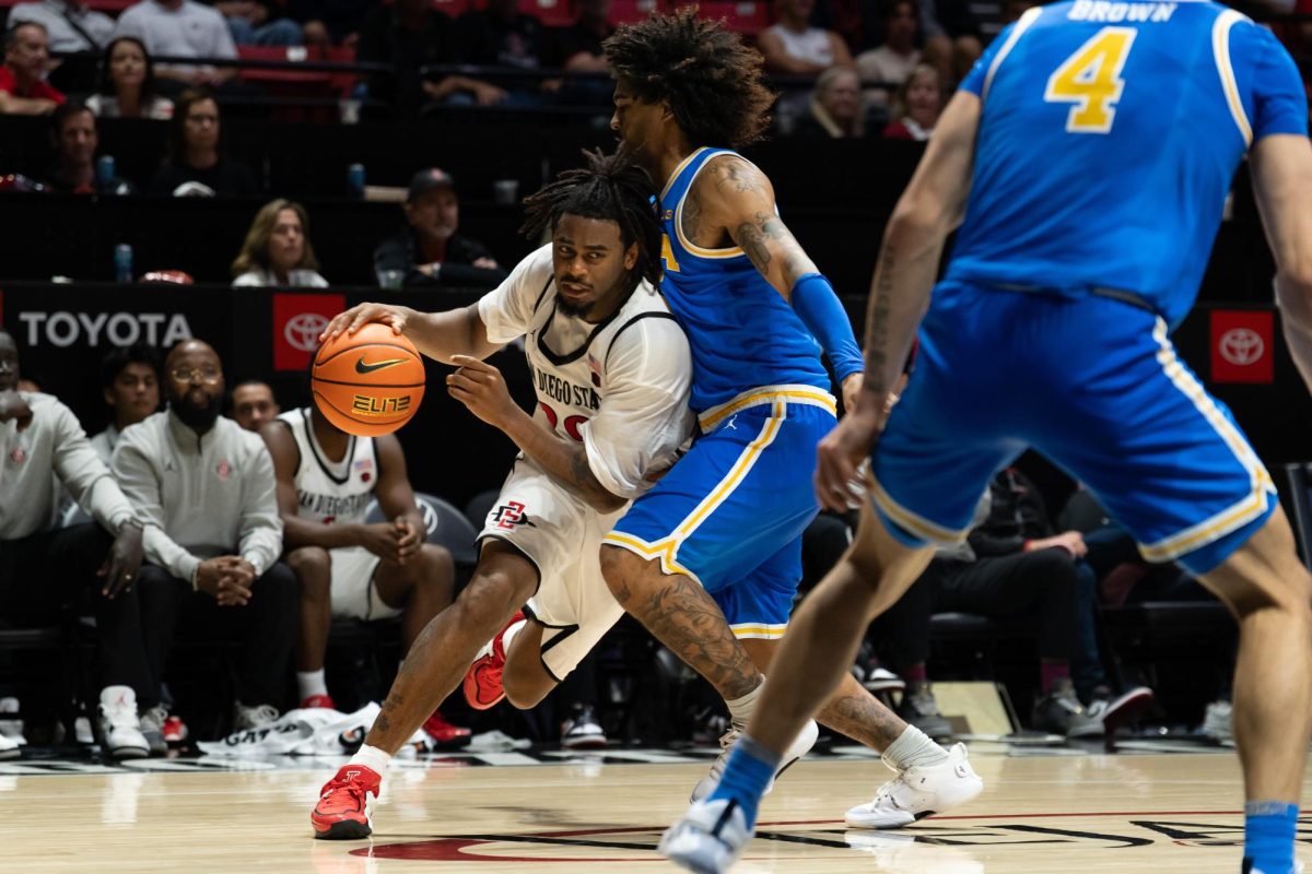Senior guard Reese Dixon-Waters drives to the basket against UCLA senior guard Skyy Clark in a 67-60 loss against UCLA on Friday, Oct. 17 at Viejas Arena 