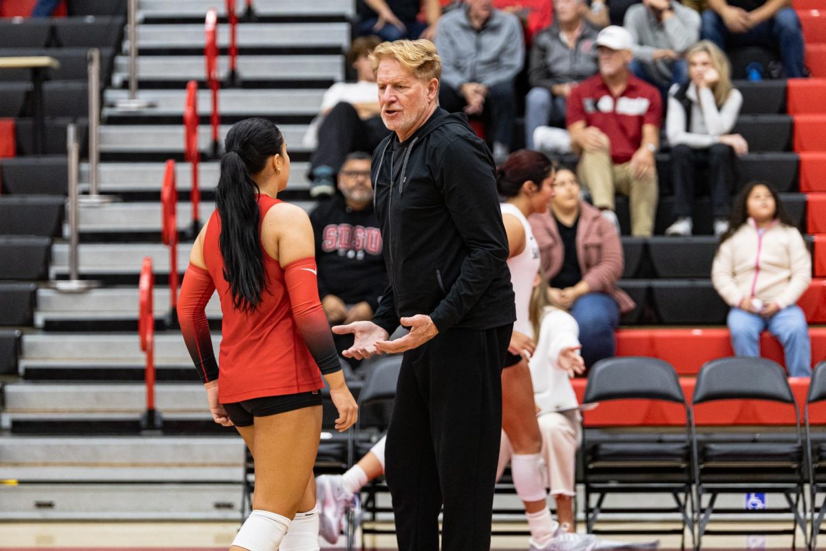 Assistant coach Steve Timmons discusses strategy with freshman libero/defensive specialist Zara Stewart during a match against Wyoming on Saturday, Nov. 15, 2025, at Peterson Gym.