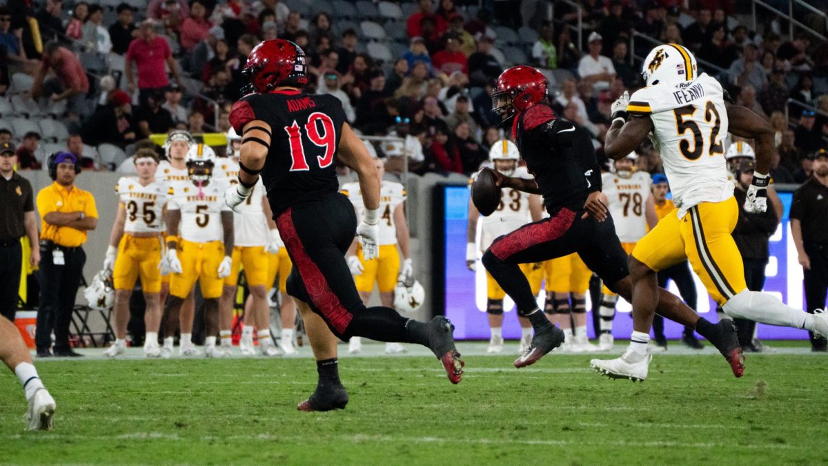 San Diego State quarterback Jayden Denegal runs out of the pocket on Nov. 1, 2025 at Snapdragon Stadium. 