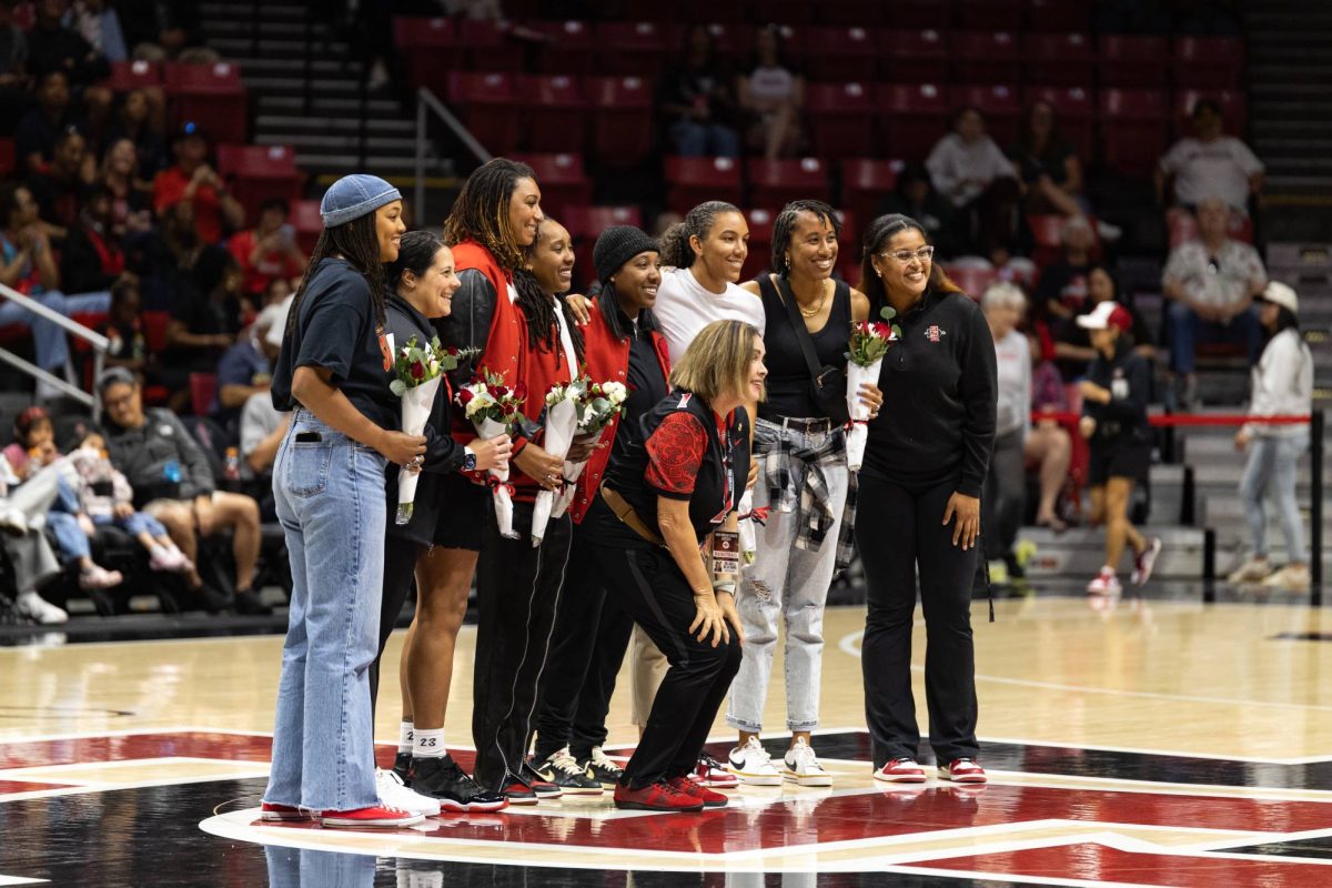 Members from the 2009-2010 San Diego State women’s basketball team receive recognition during the 16th anniversary of their  Sweet 16 March Madness run, along with president of San Diego State Dr. Adela de la Torre (front), during the halftime at the game against Nevada on Saturday, Jan. 31, 2026 at Viejas Arena.