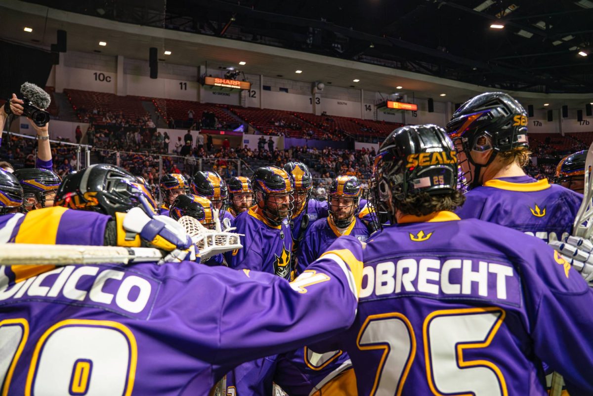 The San Diego Seals lacrosse team huddles together during a game at Pechanga Arena. Image courtesy of the San Diego Seals. 