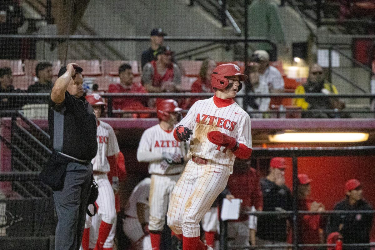 Aztec second baseman Max Farrell crosses the plate to extend the lead on a Tyce Peterson double to left-center field. 
