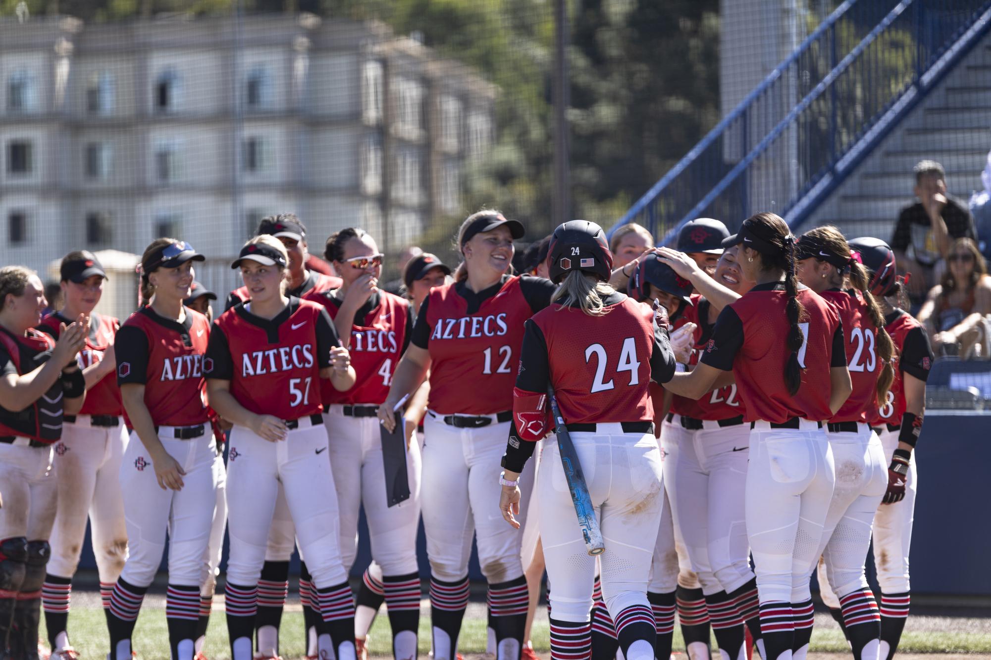 The Aztecs celebrate junior utility Jazmin Williams for her third inning 2-run homer during their 16-2 loss on Friday, Feb. 27, 2026 at the Reggie Smith Softball Complex at the University of San Diego. The home run marks Williams’ fourth for the season and is now one shy of her career high of 5 home runs in a season.