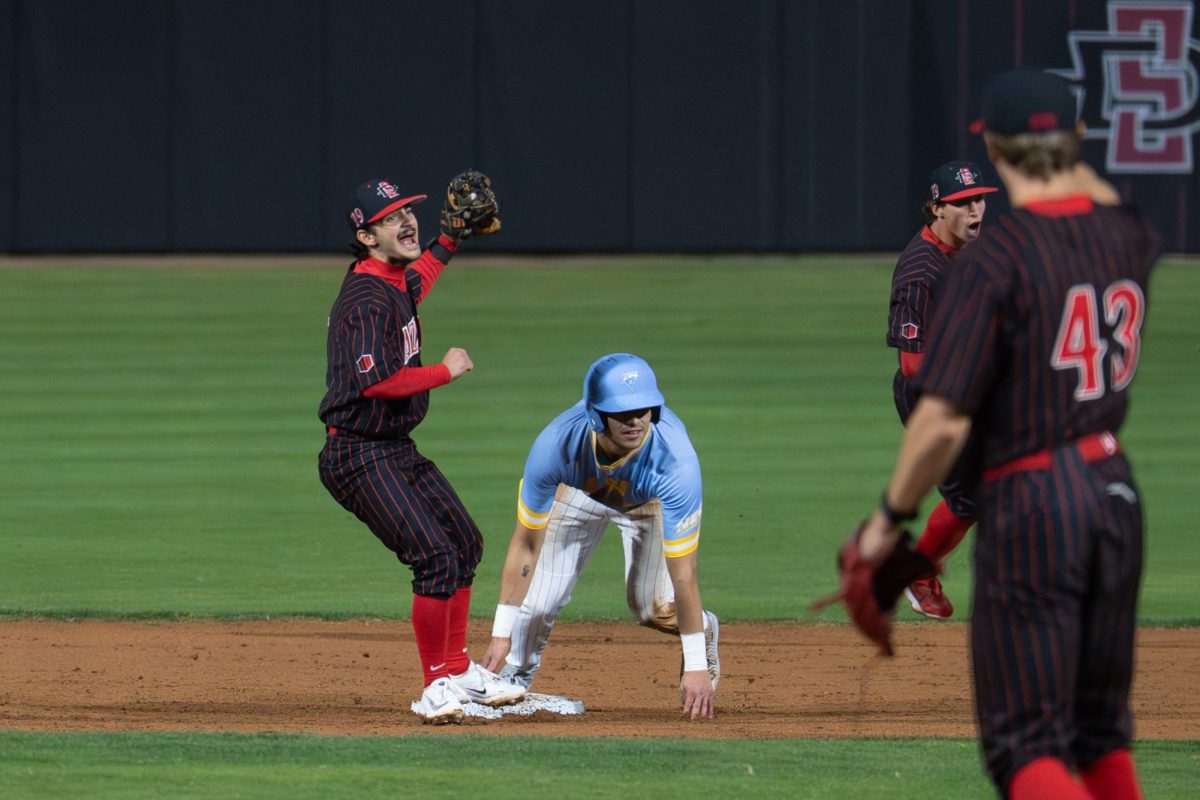 Junior infielder Dawson Santana (left) celebrates a defensive play in a 12-11 win against Long Island University, Friday, Feb. 13, 2026, at Tony Gwynn Stadium