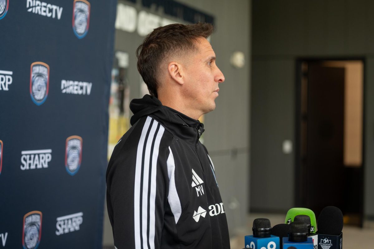 Head Coach Mikey Varas listening to questions from reporters post practice on Thursday, Feb. 19th, 2026. 