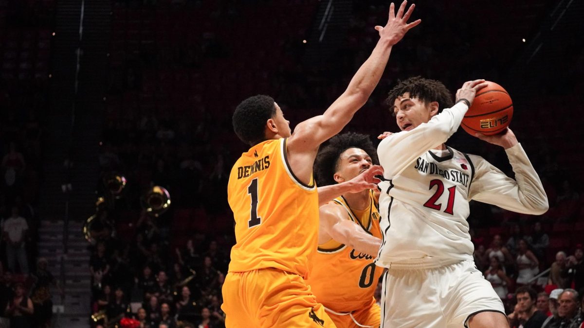 San Diego State guard Miles Byrd holds the ball away from a pair of Wyoming defenders at Viejas Arena on Tuesday, Feb. 3, 2026. 
