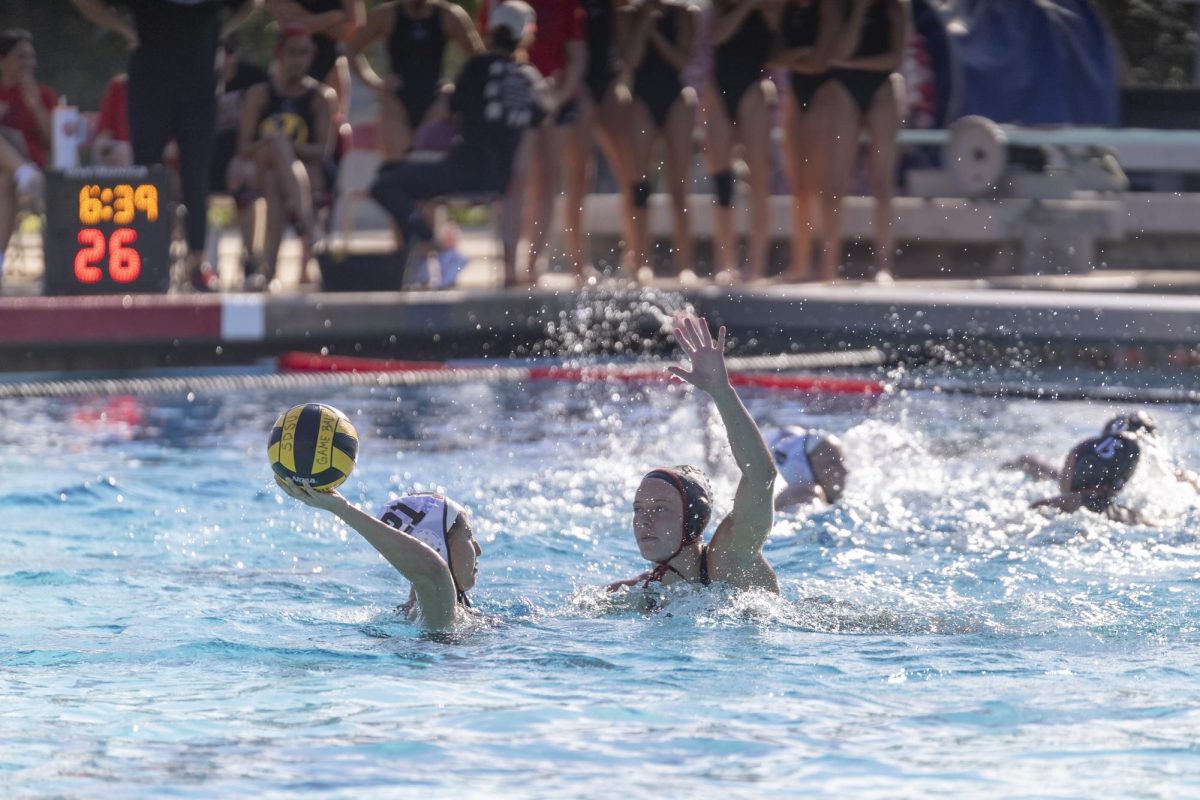 San Diego State senior center Hannah Bell provides defensive pressure on the Brown attacker, ending her Senior Day with two goals during the 12-5 Aztec win on Friday, Mar. 27, 2026 at the Aztec Aquaplex.
