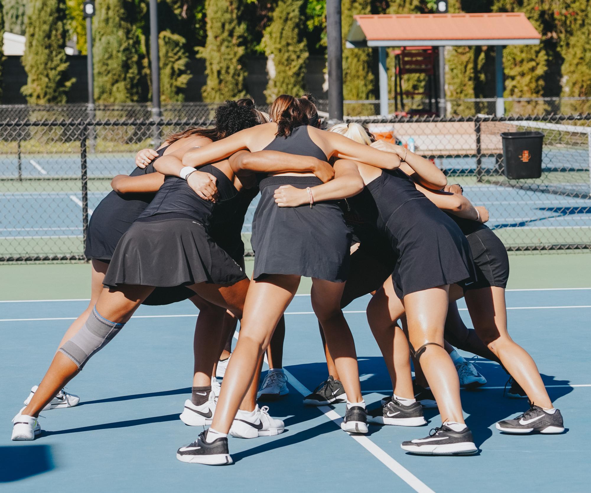 Aztecs women's tennis team huddle up before their match up vs Fresno State on Friday March 13th