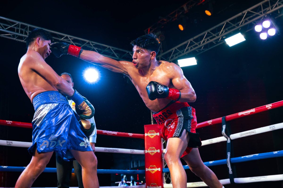 Adrian "El Ratón" Torres throwing a right-handed punch at opponent, Marco Juarez
