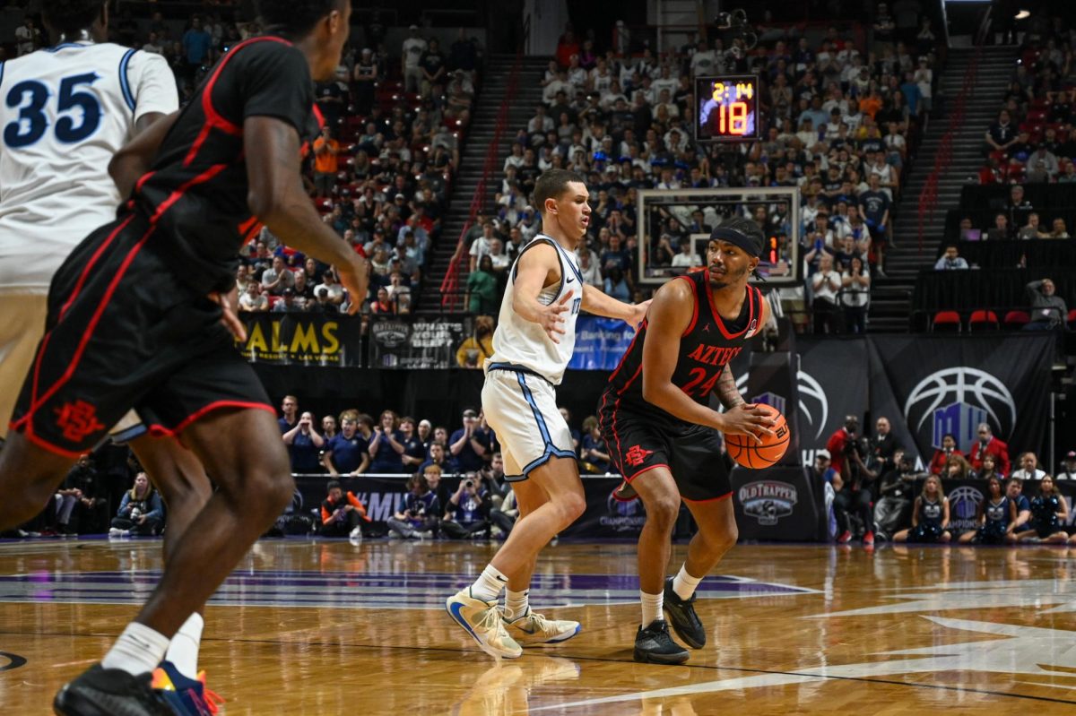 Sophomore Guard Taj DeGourville looks to pass the ball during SDSU's game against Utah State on Sat. March 14, 2026