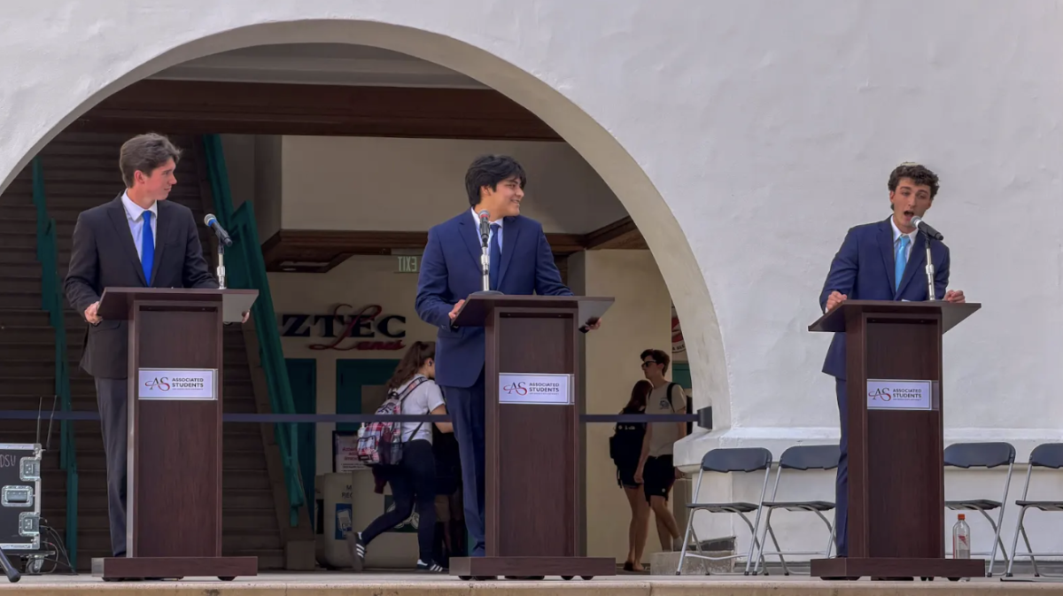 Michael Moyer, Jake Camacho and Eric Krog (left to right) debate each other in their race for Associated Students vice president of financial affairs at the Conrad Prebys Aztec Student Union Courtyard on March 17, 2026. 