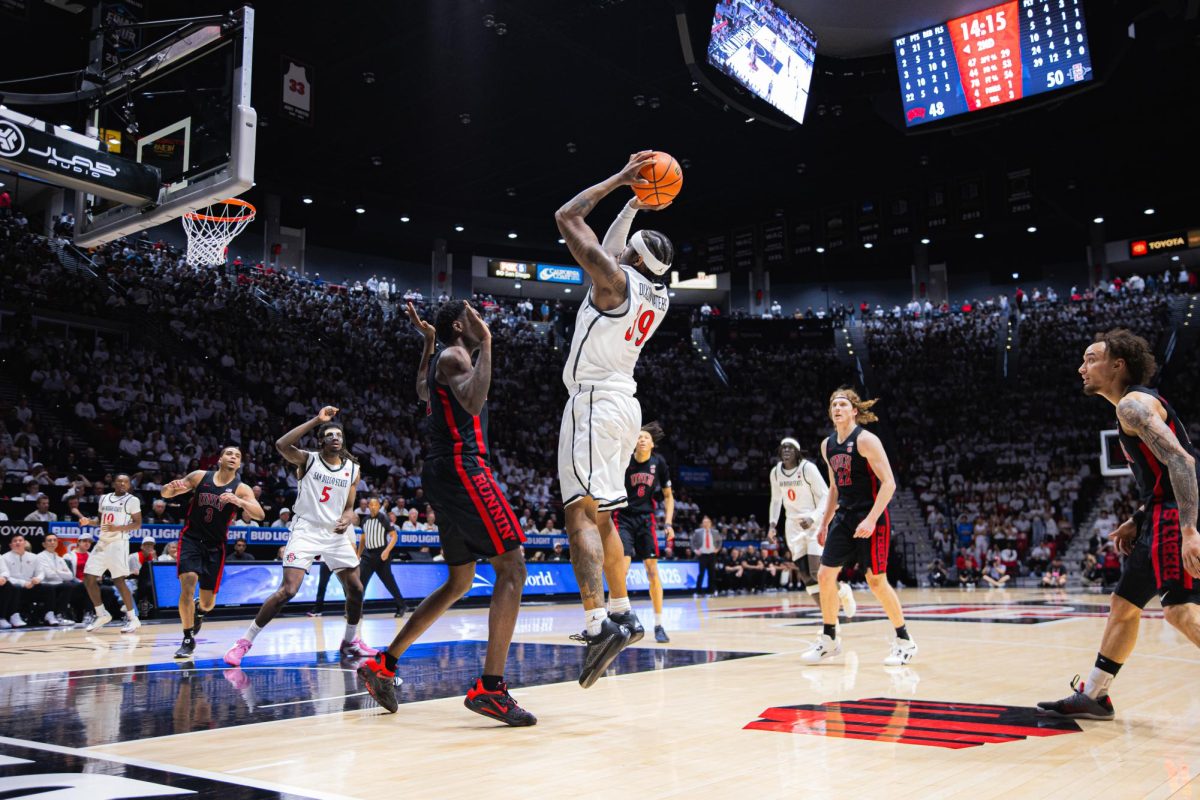 SDSU senior guard Reese Dixon-Waters rises over a UNLV defender late in the second half leading the Aztecs to a 89-86 victory on Friday, March 6, 2026, at Viejas Arena. 