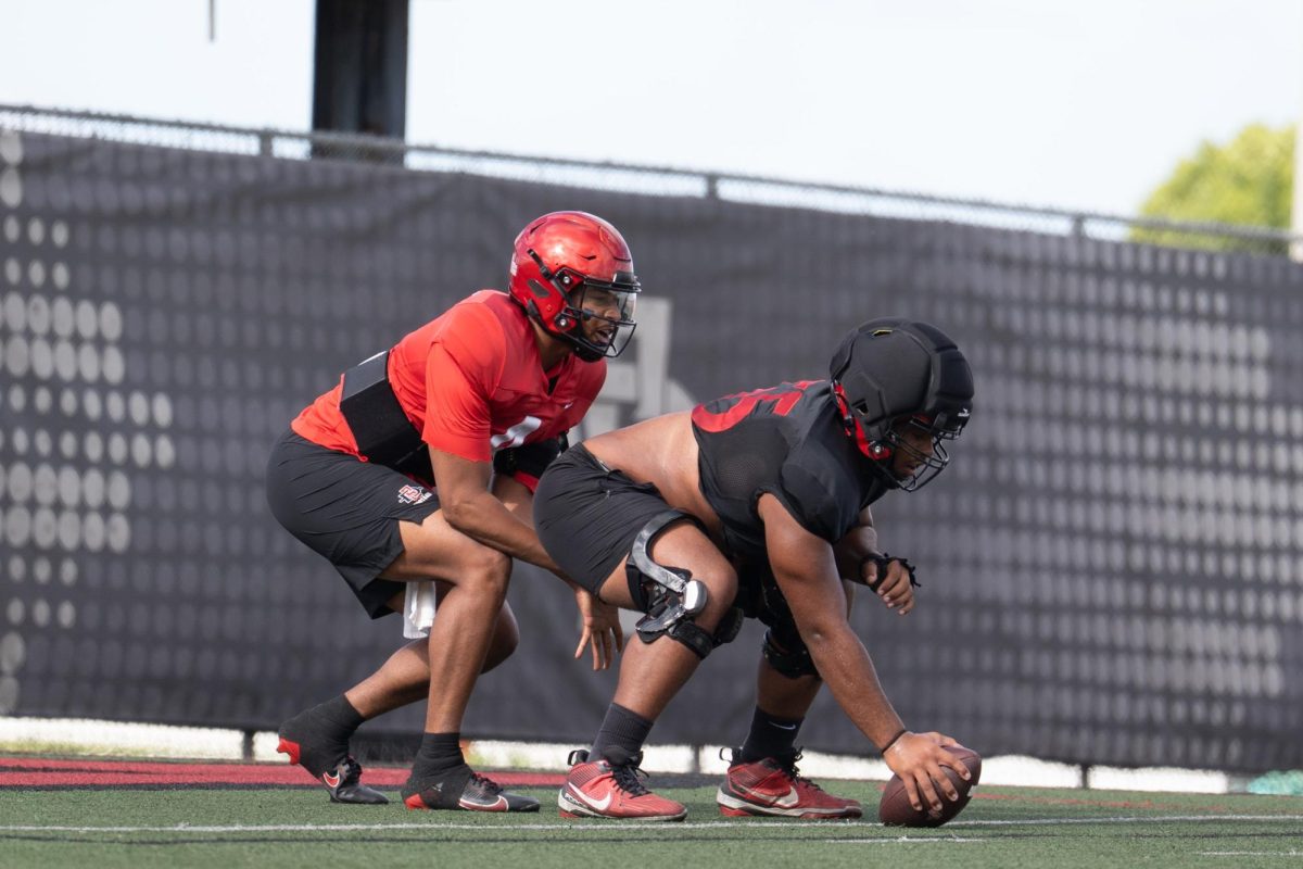 San Diego State sophomore Michael Leville Watkins, right, hikes a ball for junior quarterback Jayden Denegal, left, during a spring practice at San Diego State University, Tuesday, April. 14, 2026, San Diego, CA.