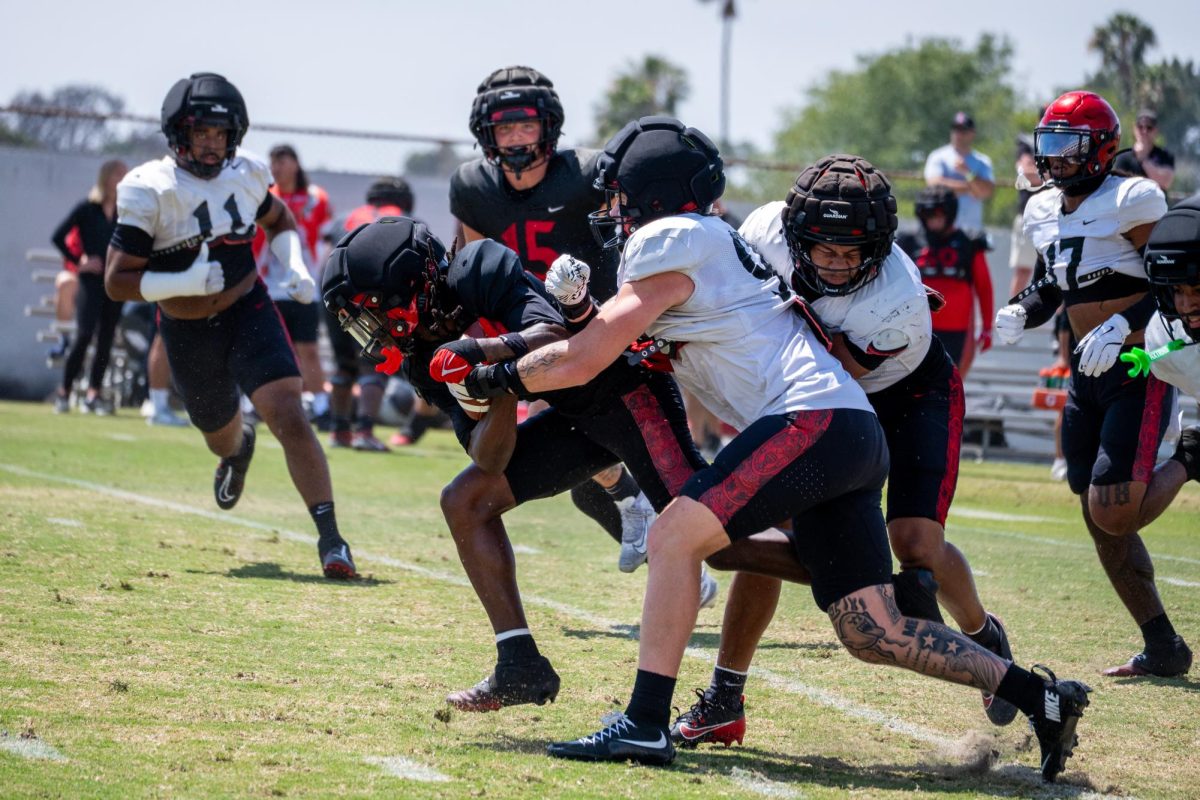 Wide receiver Donovan Brown (14)  grabs the punt and fights through contact at the SDSU spring game Tuesday, May 2, 2026, at San Diego state university 