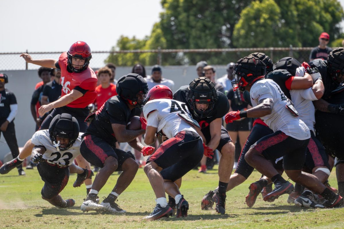 Running back Christian Washington (20) pushes through multiple defenders at the spring game on Tuesday, May 2, 2026, at San Diego state university 